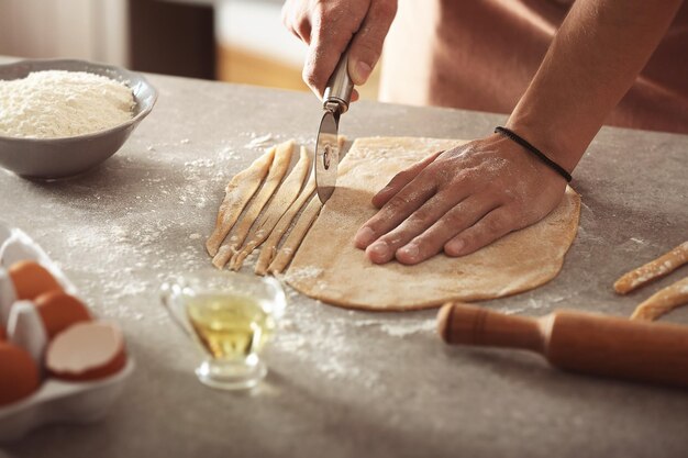 Hands preparing dough on a table